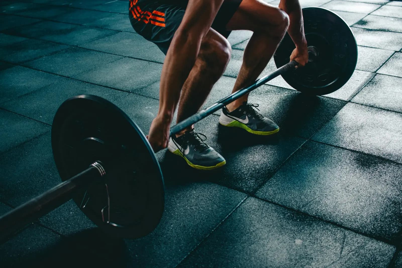 Dumbbells and weight plates on a gym floor