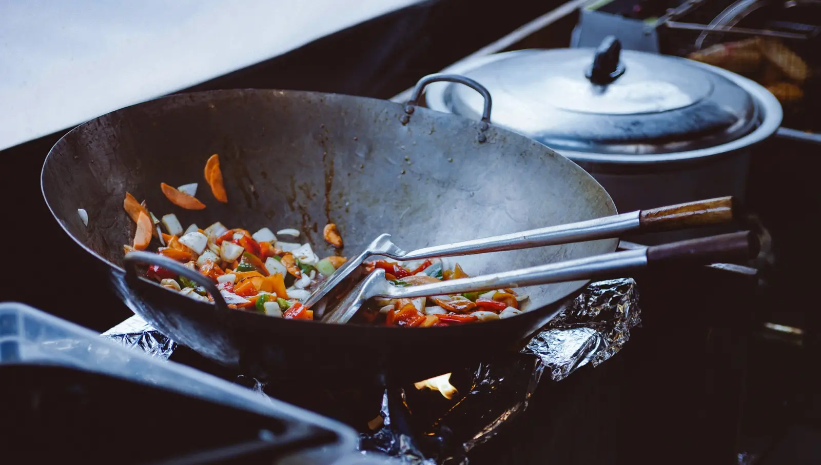 Fresh vegetables being cooked in a wok